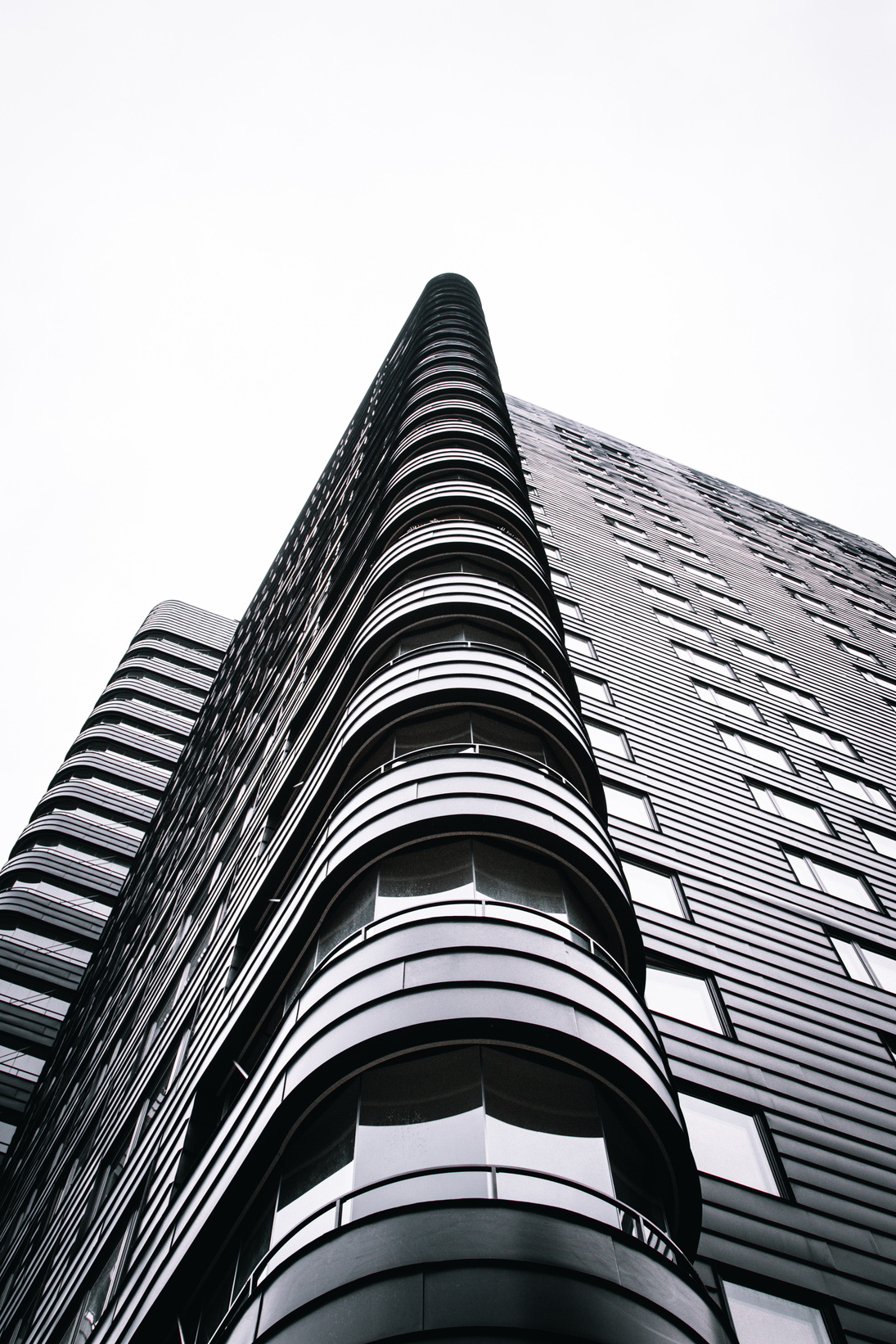 A Grayscale Photo of a Building Under the White Sky